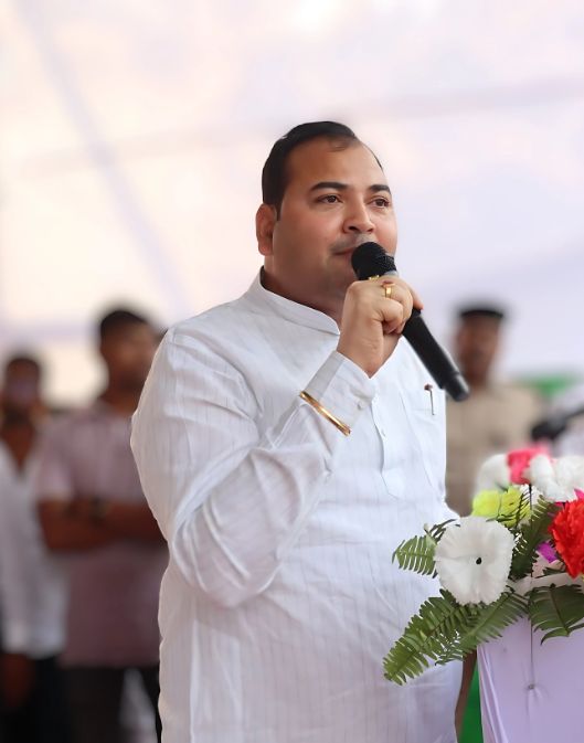 Setu Ji interacting with villagers during a local community meeting, listening attentively and engaging with warmth.